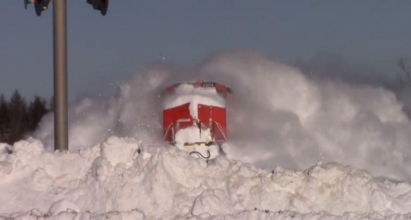 Train ploughs through snow